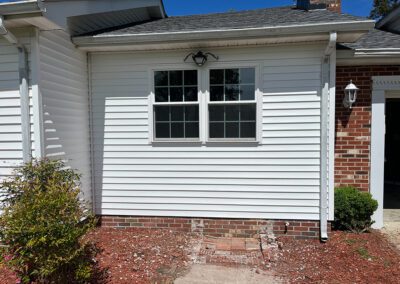 Window with completed construction and new siding