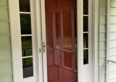 Red door with white painted accents before replacement